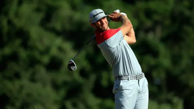 Dustin Johnson hits his tee shot