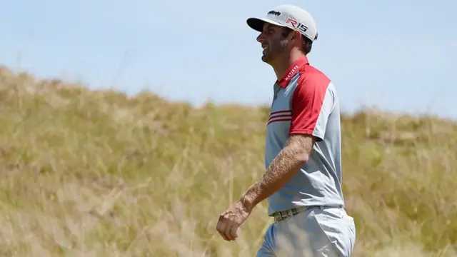 Dustin Johnson walks on the course