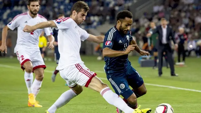 Scotland's Ikechi Anya is tackled by Georgia's Solomon Kverkvelia