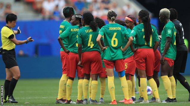 Cameroon players protest in the middle of the pitch