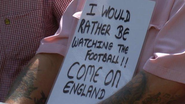 A fan holds up a sign at Wimbledon