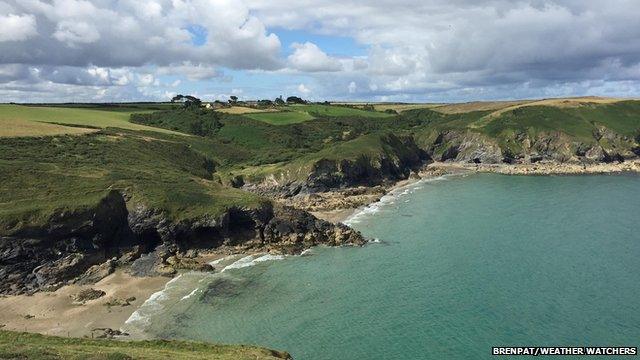 Crystal blue waters in a bay, under cloudy skies