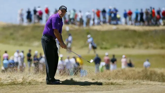 Phil Mickelson looks after his shot