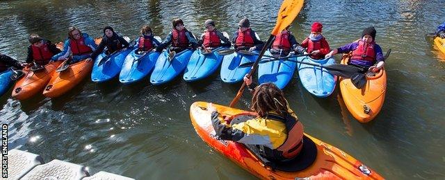 coach and young kayakers