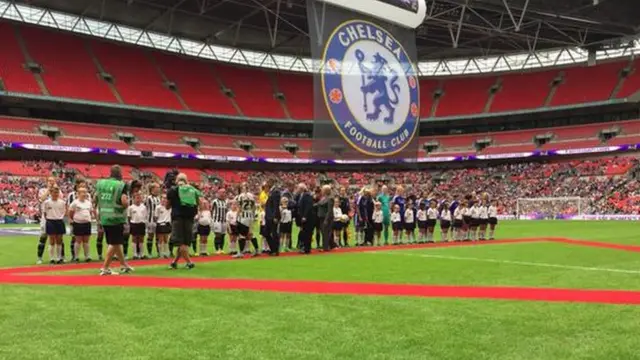 Players stand for the national anthem