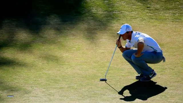 Rory McIlroy lines up a shot