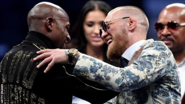 Mayweather and McGregor embrace at the post-fight news conference