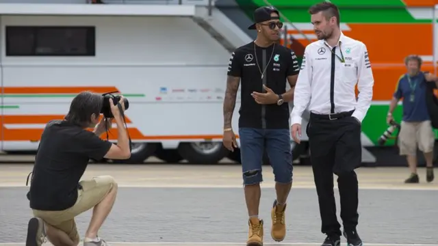 Lewis Hamilton walks through the paddock at Silverstone