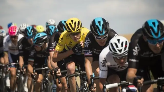 Chris Froome (in yellow) in the midst of his Team Sky riders