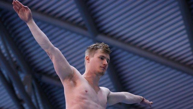 Jack Laugher with his arms out wide before a dive