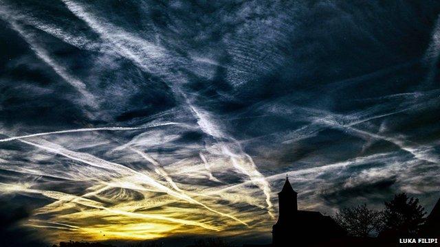 Contrails across a sunset sky