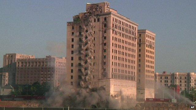 A vacant former hotel in Detroit starts to collapse as it is demolished by "implosion" to make way for a new hockey arena