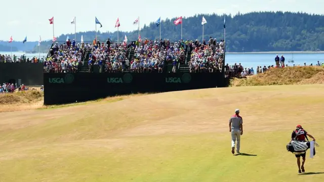 Dustin Johnson walks across the course