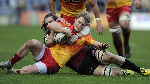 Edinburgh's Ben Toolis tackles Aled Davies of the Scarlets