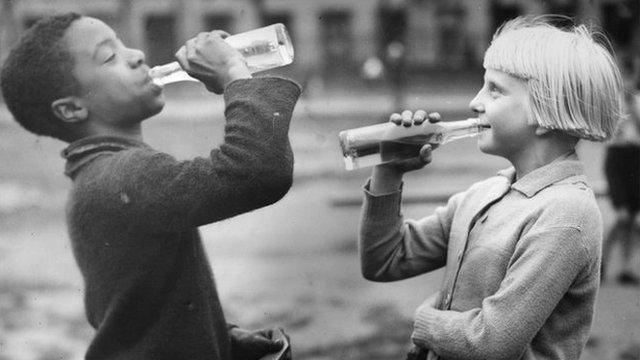 Children sharing a drink together in Tiger Bay