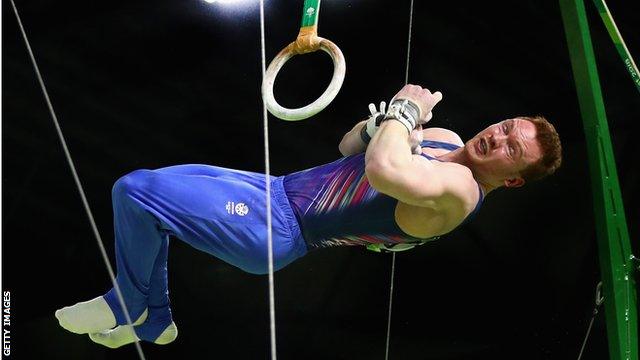 Dan Purvis competes on the rings at the Commonwealth Games