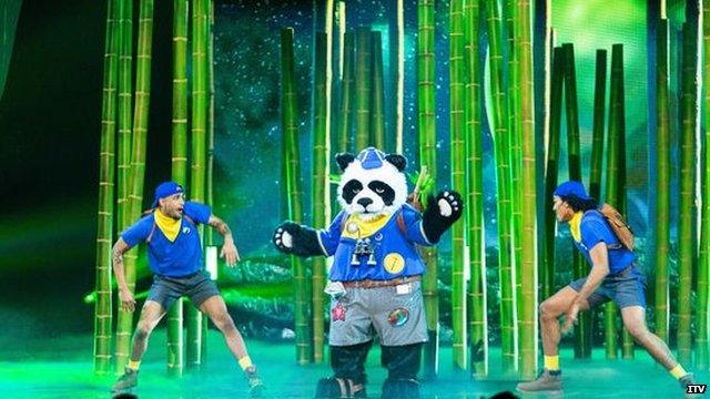 A photo of Panda and back up dancers on The Masked Singer