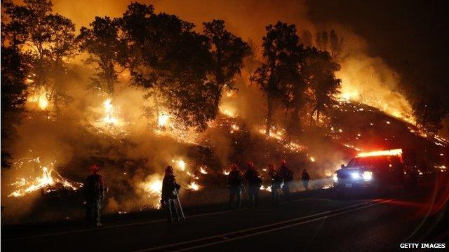 Firefighters with the Marin County Fire Department"s Tamalpais Fire Crew monitor a backfire as they battle the Valley Fire on September 13, 2015 near Middletown, California