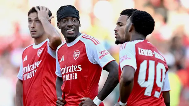 Noni Madueke of Arsenal talks to team-mate Myles Lewis-Skelly following the pre-season friendly match between Arsenal and Athletic Bilabo