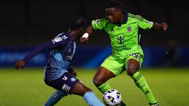 Fulham and Wycombe player contest for the ball