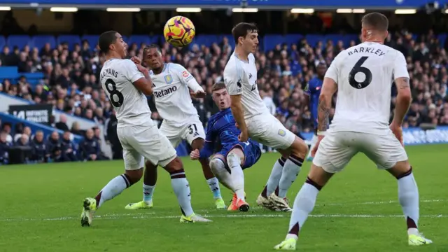 Cole Palmer of Chelsea scores his team's third goal during the Premier League match between Chelsea FC and Aston Villa FC at Stamford Bridge. 