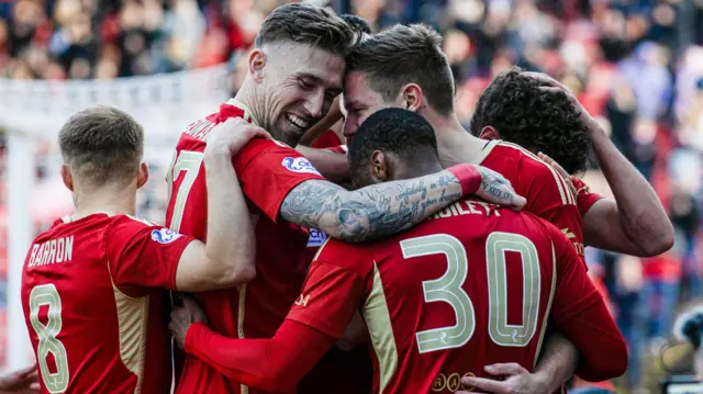 Aberdeen's Stefan Gartenmann celebrates with his teammates as he scores to make it 1-0 during a cinch Premiership match between Aberdeen and Motherwell at Pittodrie Stadium