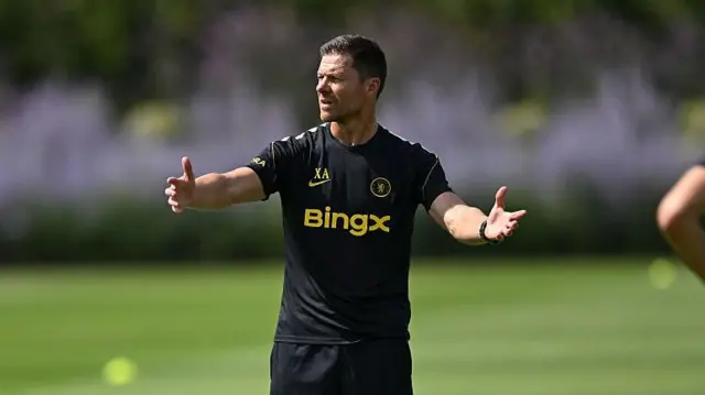 Xabi Alonso with his arms outstretched during his first training session