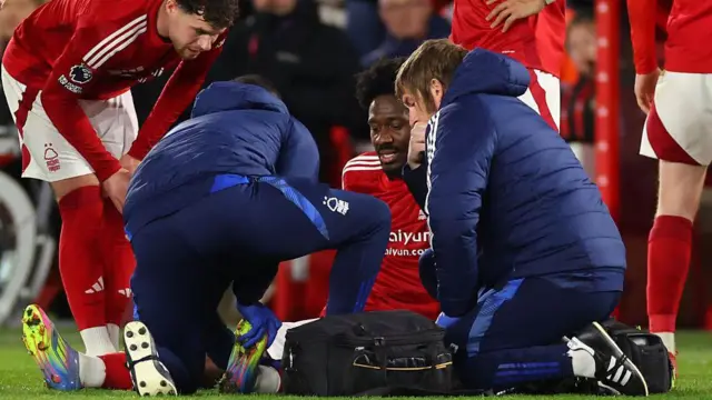 Ola Aina of Nottingham Forest is treated