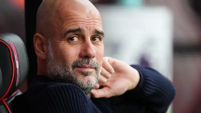 Pep Guardiola looks on from the dugout