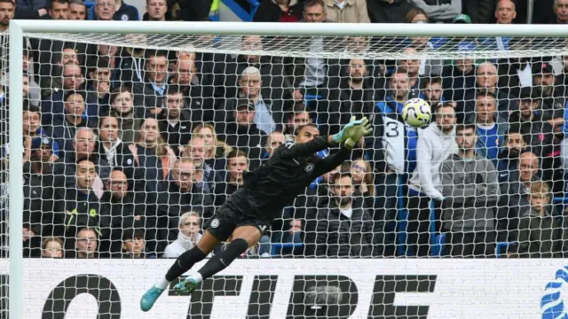 Robert Sanchez, Chelsea goalkeeper, makes a diving save during the Premier League match between Chelsea and Nottingham Forest at Stamford Bridge