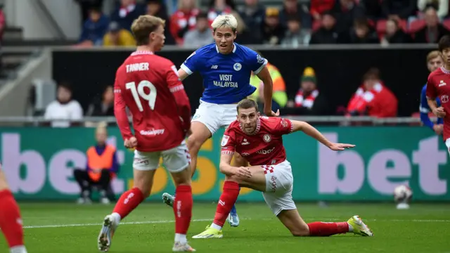 Cardiff City's Rubin Collwill heads the ball between two Bristol City players