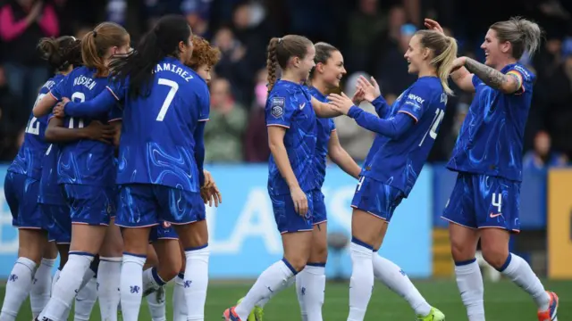 Chelsea players celebrate their goal against Manchester United.