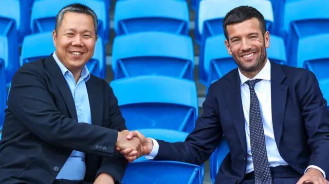 Cardiff Chief Executive Ken Choo (left) and Brian Barry-Muprhy shake hands in the seats at Cardiff City Stadium