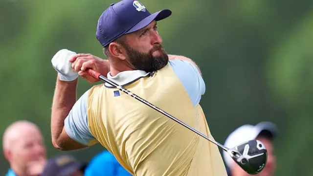 Jon Rahm holding a driver