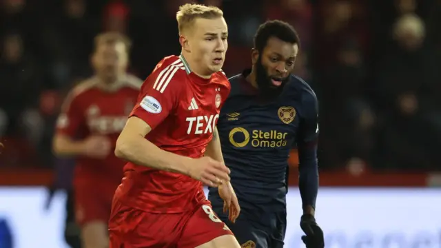 Aberdeen's Topi Keskinen and Hearts' Beni Baningime in action during a William Hill Premiership match between Aberdeen and Heart of Midlothian at Pittodrie Stadium, on January 12, 2025