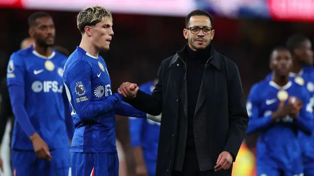 Alejandro Garnacho and Liam Rosenior clasp hands after defeat at Arsenal
