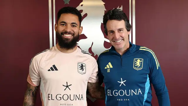 Douglas Luiz of Aston Villa poses for a picture with Unai Emery