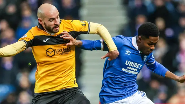 Livingston's Scott Pittman and Rangers' Jayden Meghoma