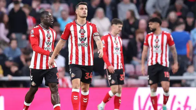 Granit Xhaka of Sunderland and teammates appear dejected