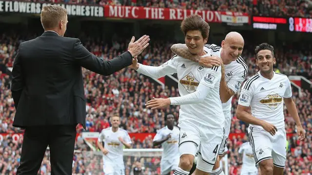 Ki Sung-Yueng celebrates with team-mates and boss Garry Monk during Swansea's win at Manchester United in 2014 