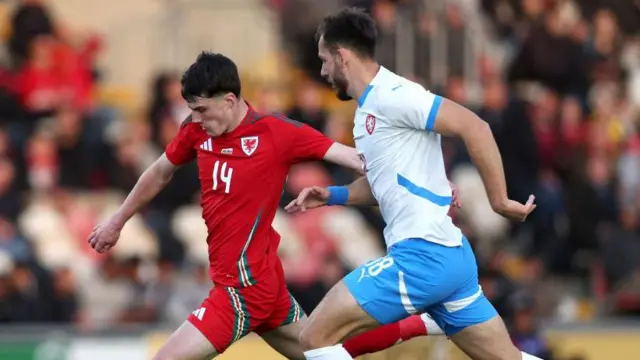 Joel Cotterill of Wales shoots under pressure from Filip Prebsl of Czechia during the UEFA European U21 Championship Qualifying match between Wales and Czechia at Rodney Parade on October 11, 2024
