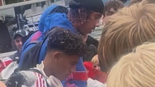 Manchester United's JJ Gabriel and Leny Yoro signing autographs after arriving in Norway on Thursday