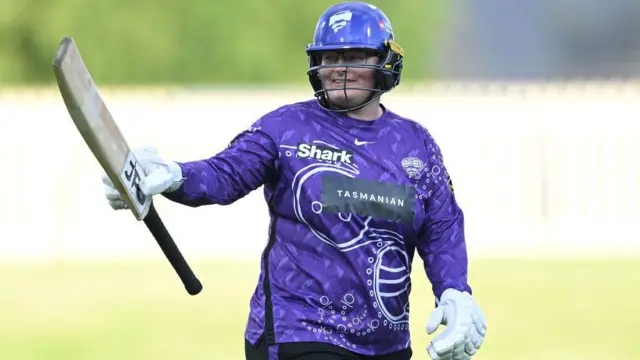 Lizelle Lee raises her bat for a century for Hobart Hurricanes