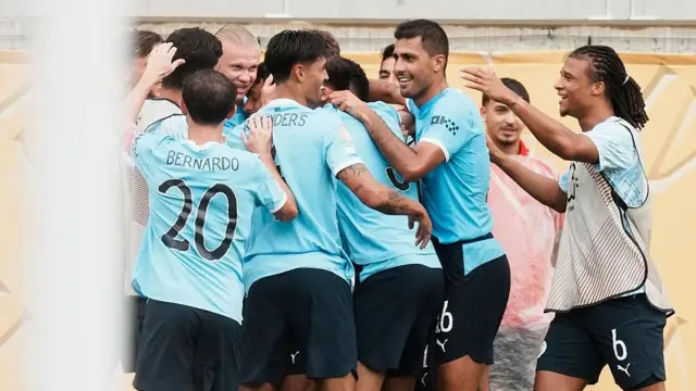 Manchester City players celebrating in a huddle against Juventus in the Club World Cup 