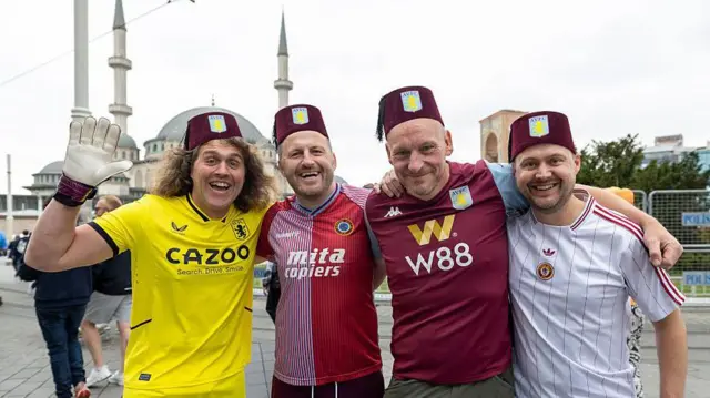Four Aston Villa fans wear fez hats in Istanbul