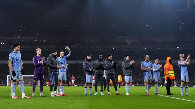 Tottenham players applaud their fans after losing to Arsenal