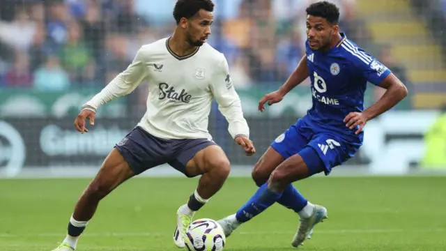 Iliman Ndiaye of Everton runs with the ball under pressure from James Justin of Leicester City during the Premier League match between Leicester City FC and Everton FC at The King Power Stadium