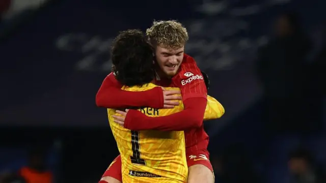 Harvey Elliott and Alisson embrace