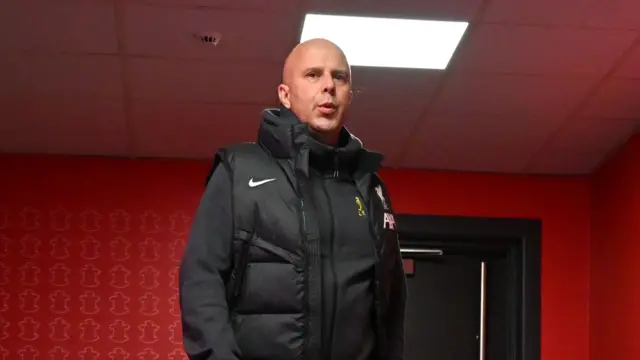 Arne Slot looks on from inside St Mary's stadium