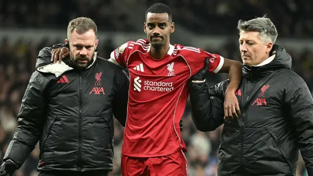 Alexander Isak leaves the pitch with medical staff - he wears Liverpool's home kit in an away match at Tottenham